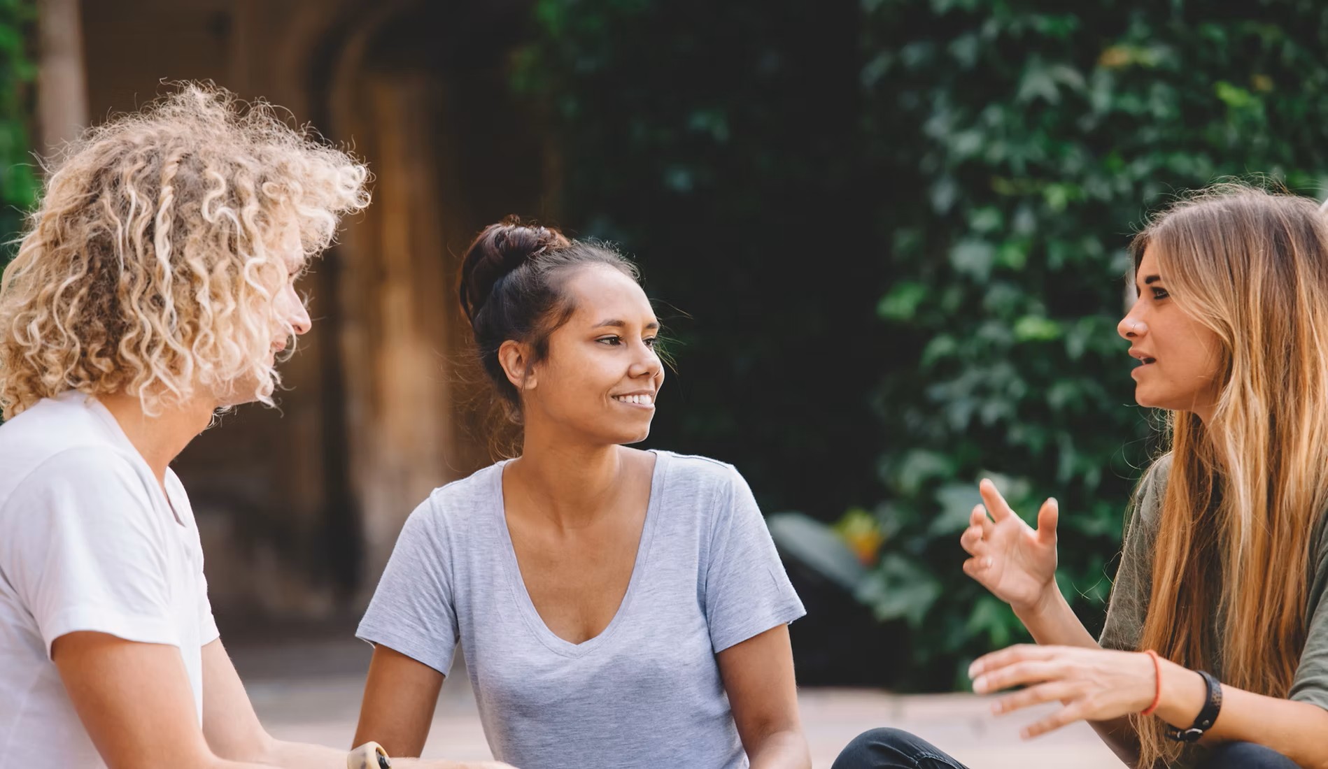 three people having a conversation